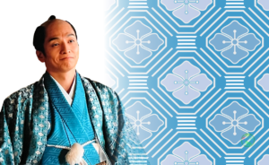 八角形と四角形を組み合わせた蜀江文様（しょっこうもんよう）を背景に、大河ドラマで一橋治済を演じる俳優の姿